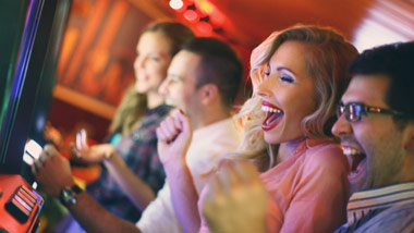 couples playing slot machines and winning