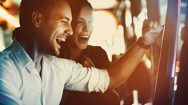 Three people at slot machine