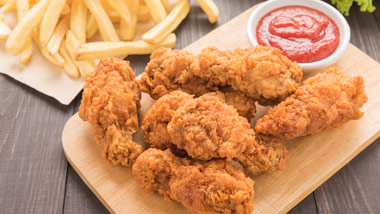 Fried chicken strips, ketchup and french fries