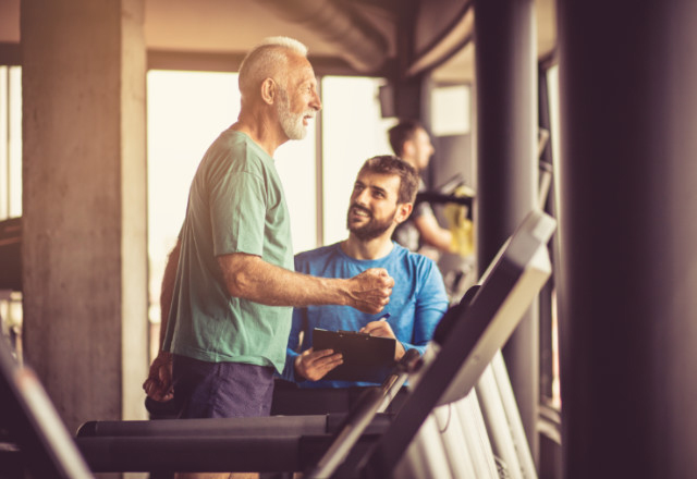 doctor supervising elder patient workout - heart and vascular institute