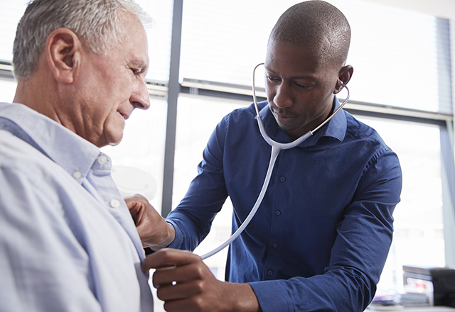 doctor listening to patient heart - heart and vascular institute