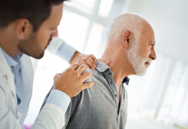 doctor examining senior patient - heart and vascular institute