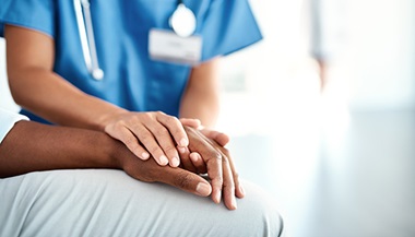 nurse holding patient's hand