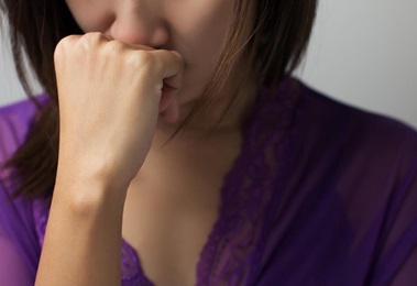 woman with hand resting on chin