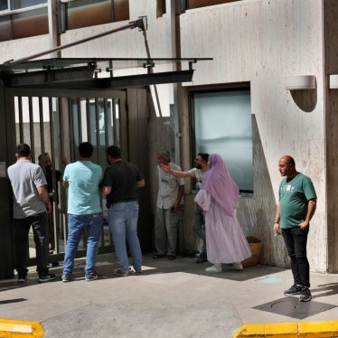 People stand outside a hospital emergency room