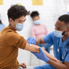 A doctor administering a vaccine to a patient. Image credit: Prostock Studio via Shutterstock