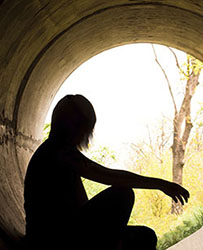 Silhouette of a person looking off in the distance