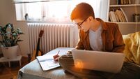 Teenage boy attending to online school class