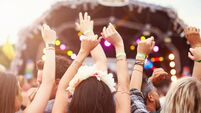 Audience with hands in the air at a music festival