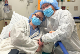 Kayla with her adoptive father in the hospital