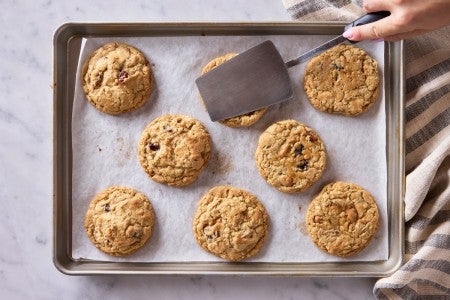 Cookie being smashed with a metal spatula