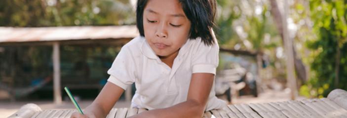 A girl writes in her notebook.