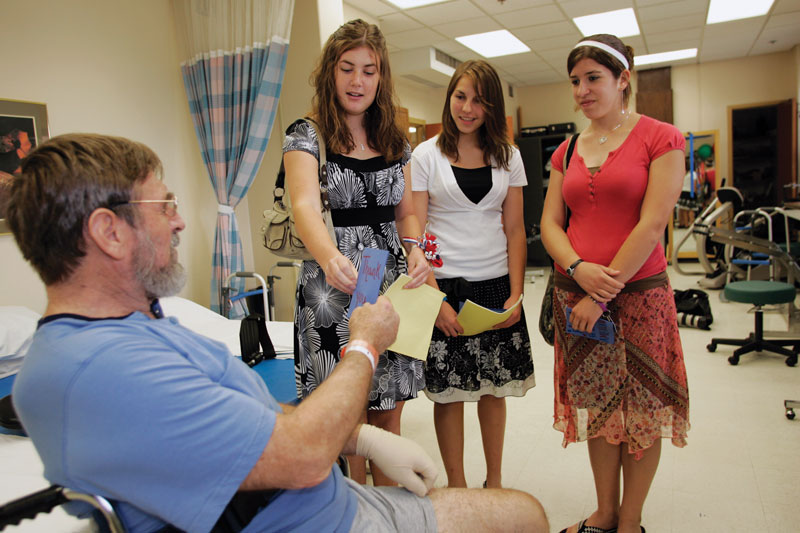 Volunteers with patient at VA