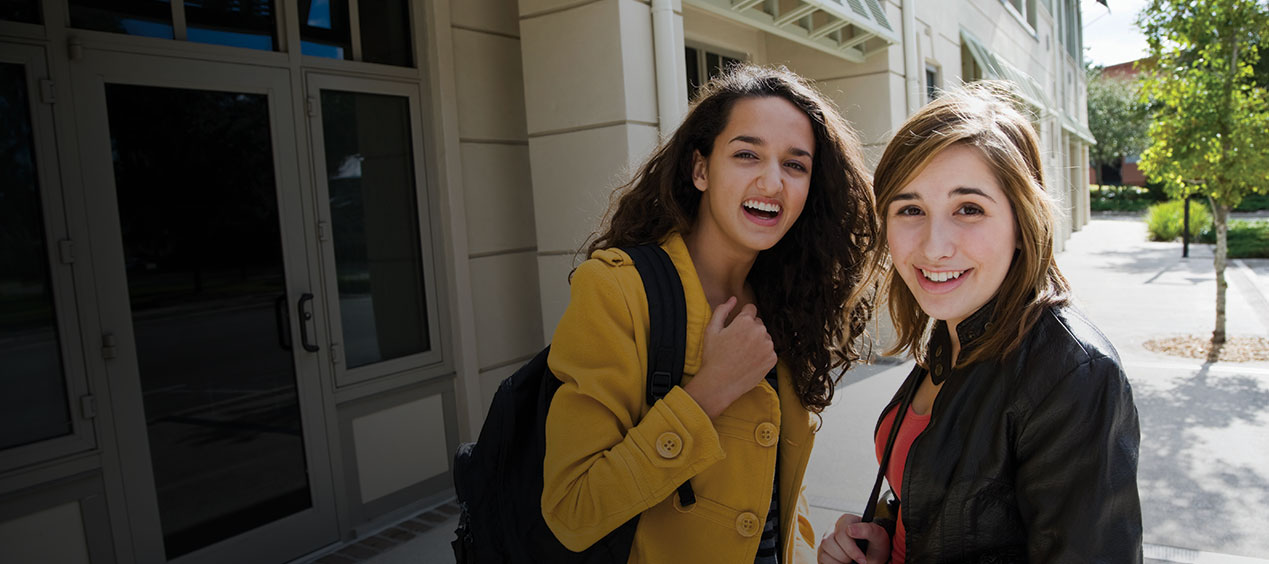 two teenage female students outside of school