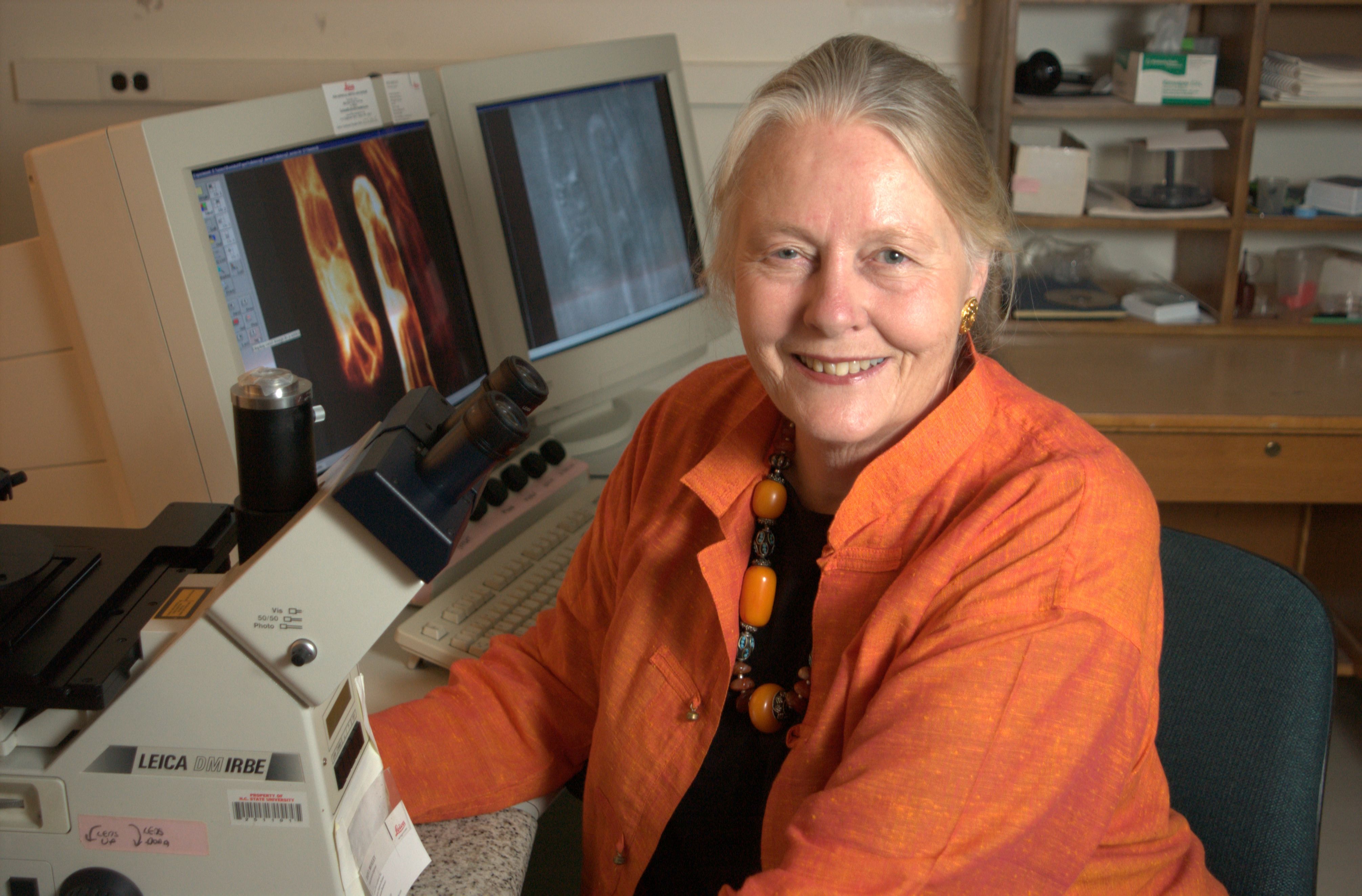 Image of Nina Allen at her desk with computers