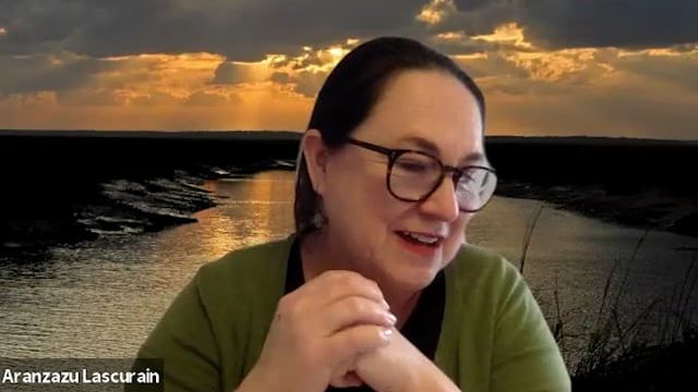 Woman talking in front of a lake