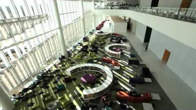 View of reading room with bright windows and colorful seating