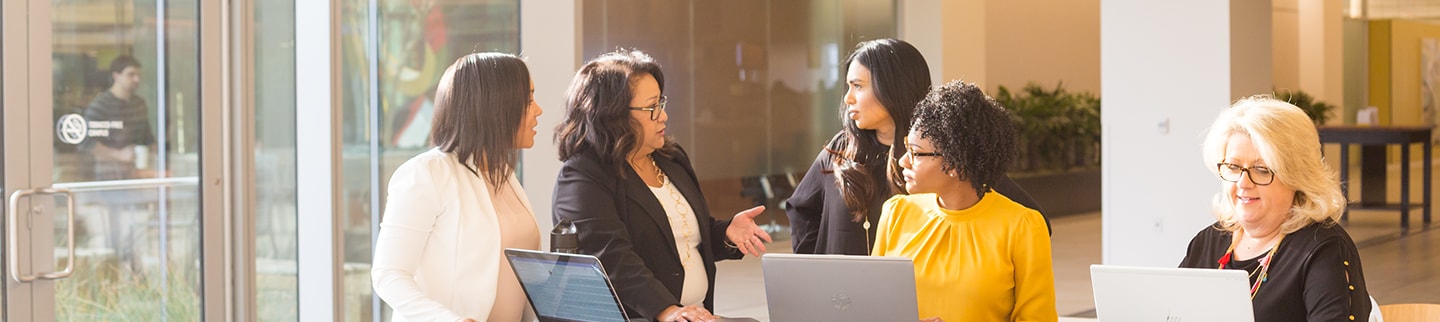 Group of women working in an open concept office