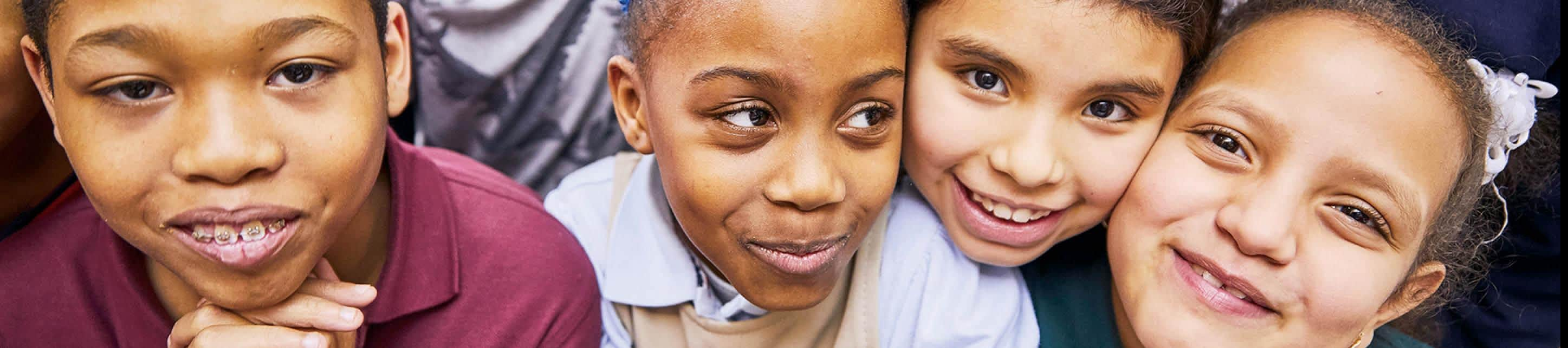 Group of diverse children smiling into camera 