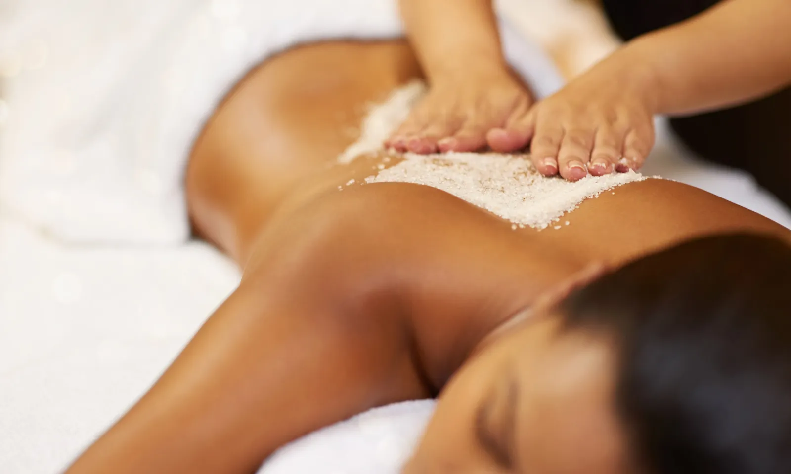 woman laying on massage bed 