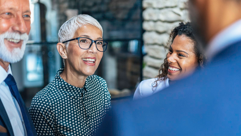 Group of people smiling and conversing