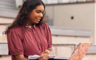 Law student at desk looking at laptop