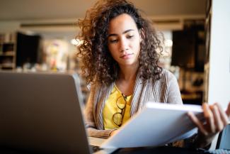 Law student at desk looking at notes