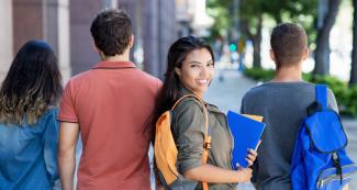 Law student smiling among peers on busy campus