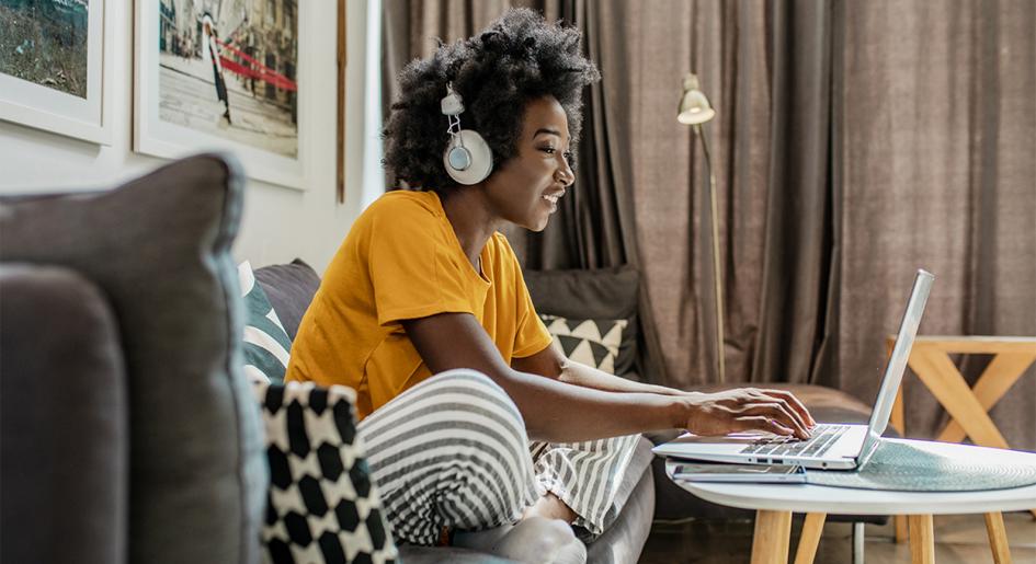 Person using laptop with headphones on