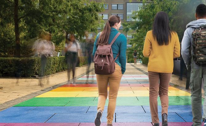 Law students walking through campus on a path that's painted in pride colors