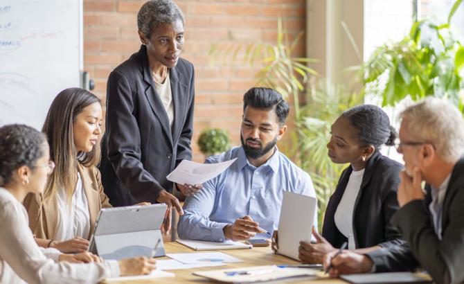 Group of individuals gathered around conference table