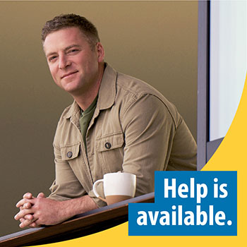 A Veteran standing at a window with text that says “Help is available.” 