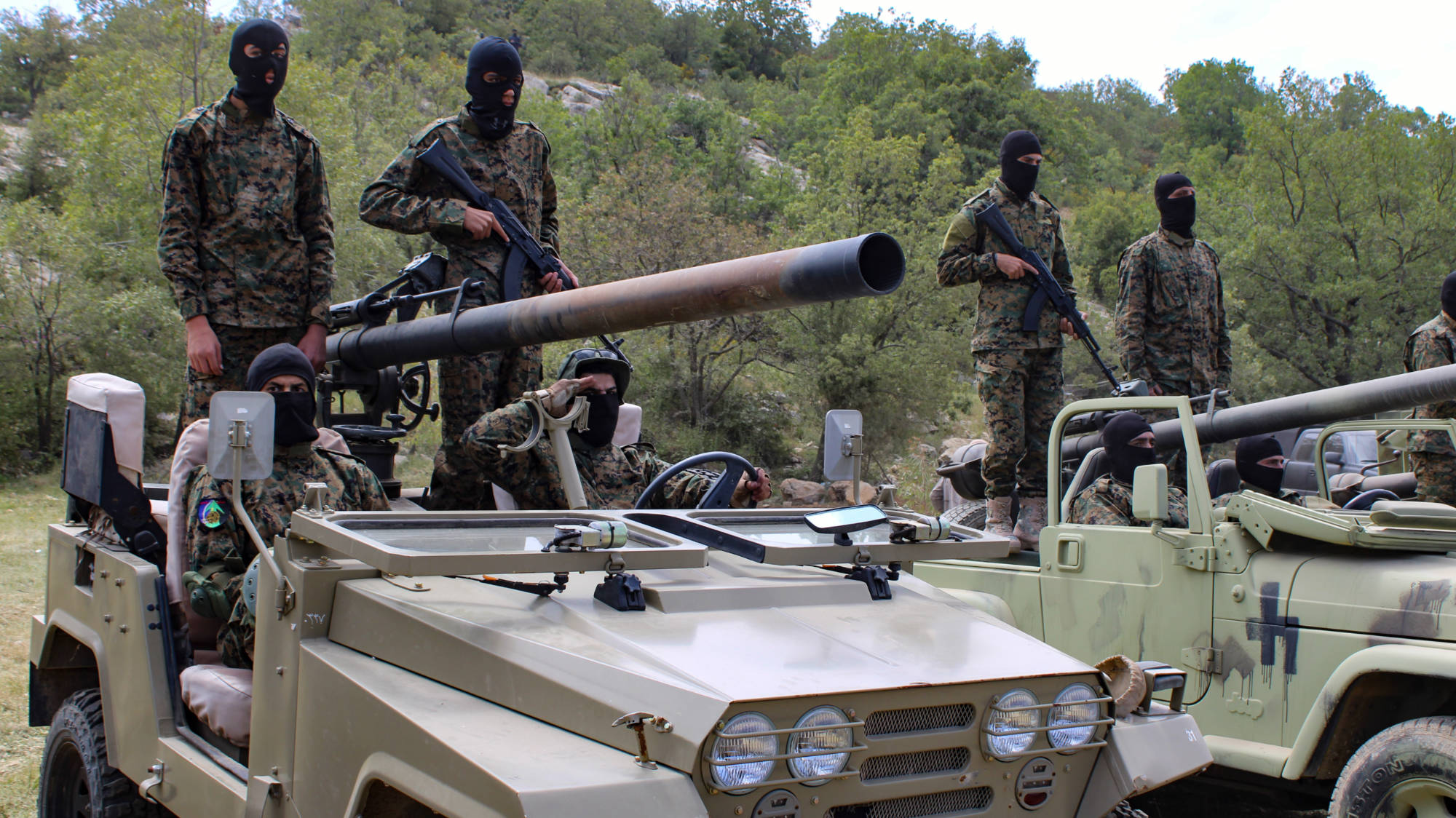 Hezbollah fighters man M40-type 106mm recoilless guns at the military show in Aramta village, Lebanon (Hanna Davis/MEE)