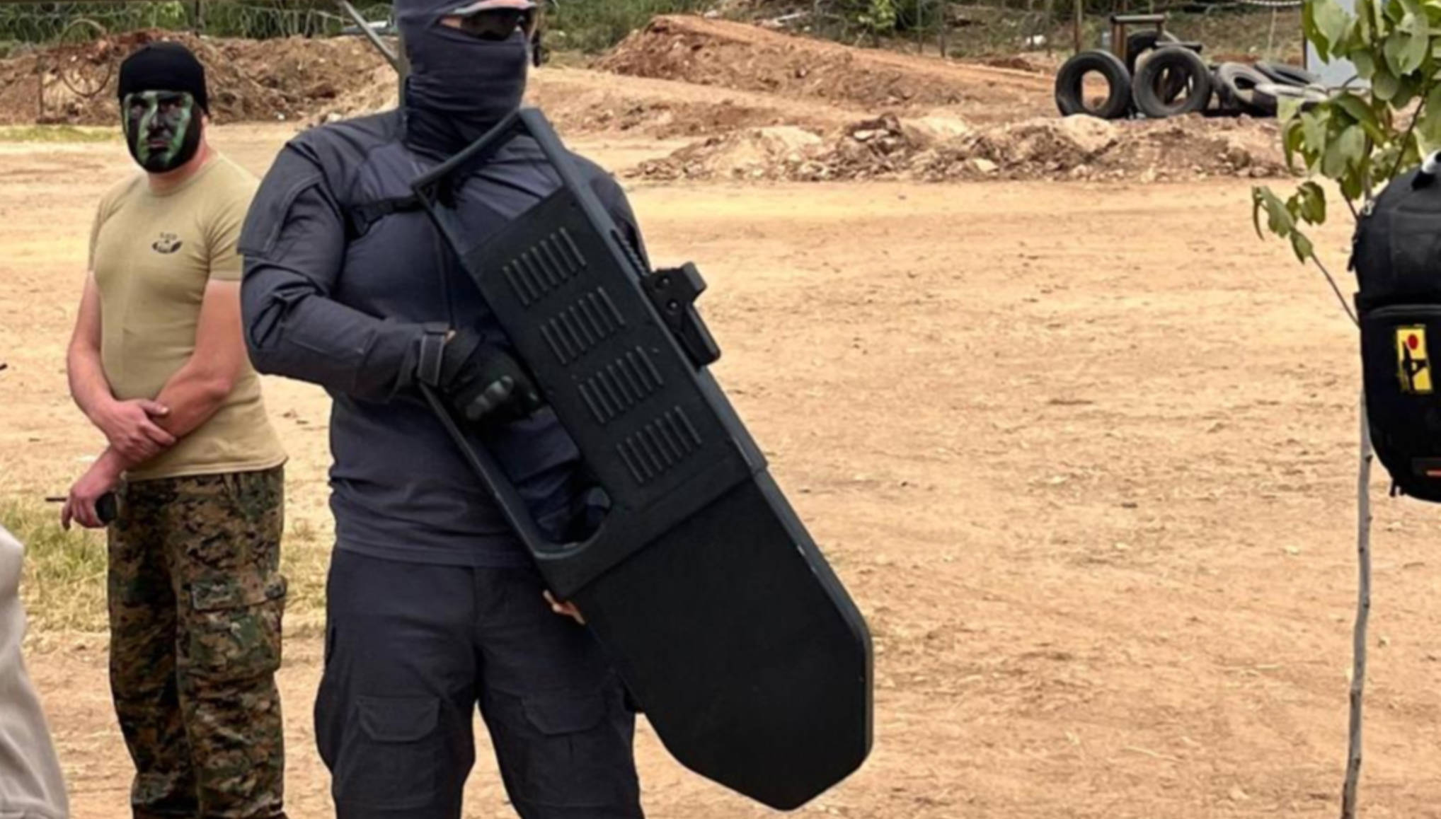 A Hezbollah fighter holds one of two anti-drone guns unveiled at the military show (Manar)