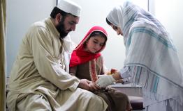 Subhan calms his daughter Afia as she receives injection for cutaneous leishmaniasis lesion at the MSF treatment centre in Naseerullah Khan Babar Memorial hospital, Peshawar.