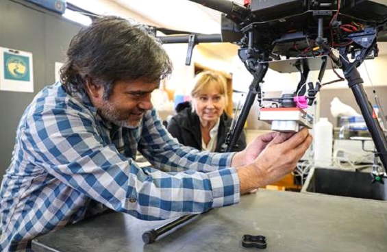 Professors work with a drone in a classroom