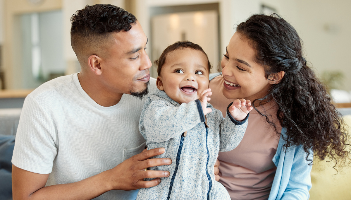 Young parents with a smiling baby small