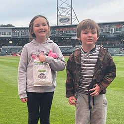 Smiling children standing in the infield