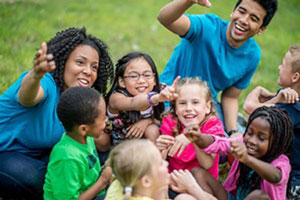 Group of kids outdoors with teachers.