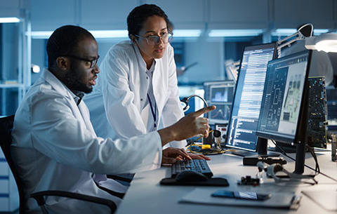 A man and a woman work together in a computer lab