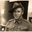 Man in military uniform with hat smiling