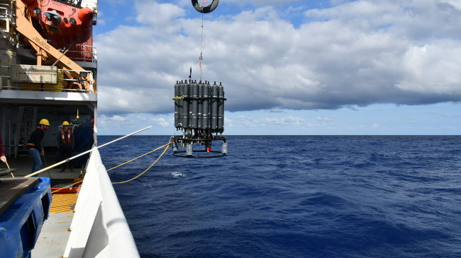 Photo of a rosette of sample bottles being recovered from the water during the 2023 A16N GO-SHIP cruise on the NOAA Ship Ronald H. Brown, which traveled from Suape, Brazil, to Reykjavik, Iceland.