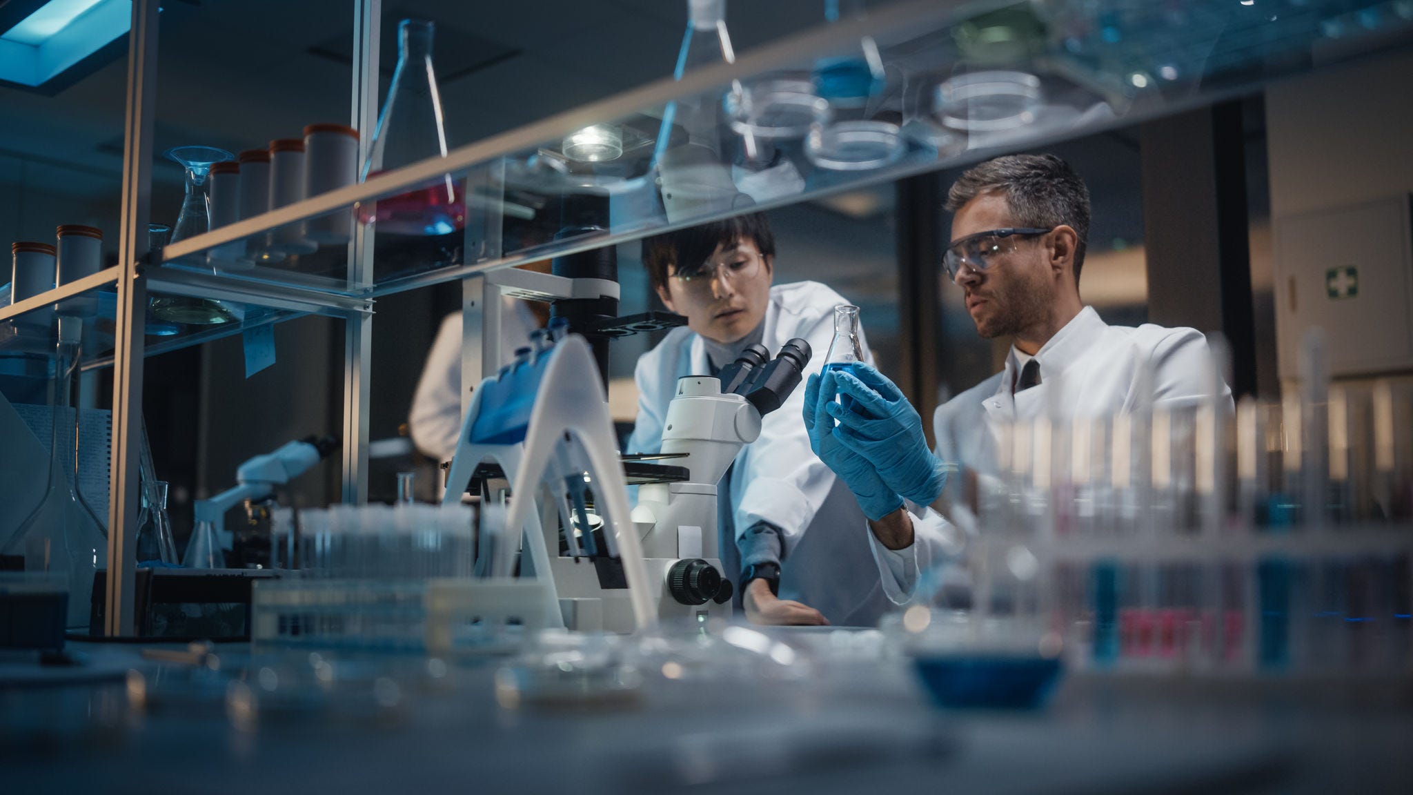 Modern Medical Research Laboratory: Team of East Asian and Caucasian Scientists Work on Laptop, do Data Analysis, Use Microscope. Advanced Lab for Medicine, Biotechnology Development. Evening Time; Shutterstock ID 1884615343; NP: OECD.org