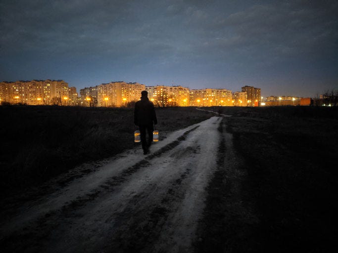 A man in the dark carries water home - Getty images 1412049585