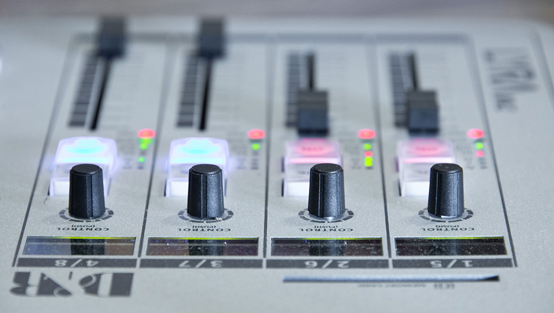 Close up of faders on a broadcast radio desk