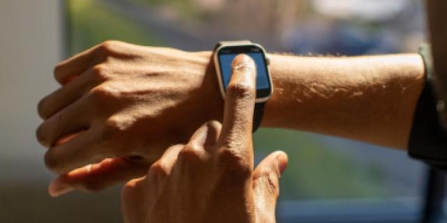 an employee punching in with their smart watch