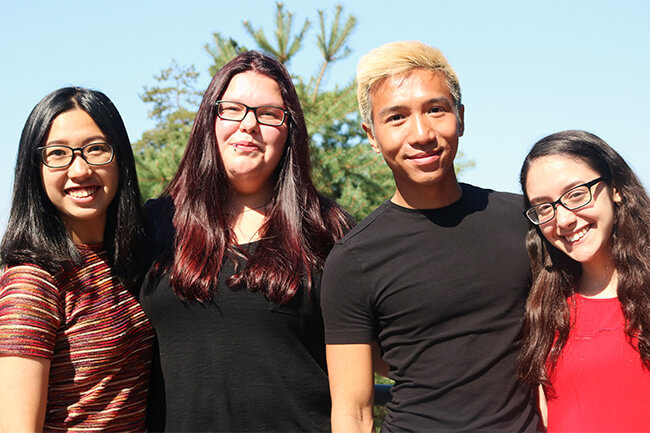 Four international students smiling at the camera