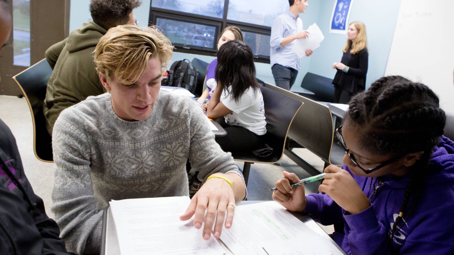 Princeton student and high school student look at handout together