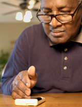 man looking at diabetes meter