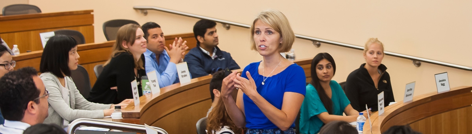 banner image: shows a teacher at the front of a classroom looking out at her students